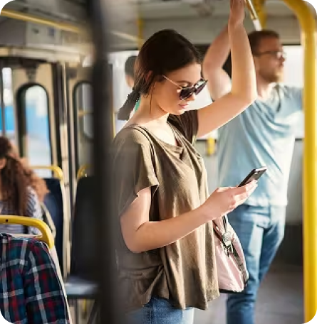 Transit rider checking phone on bus